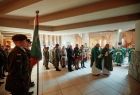 Kapłani oraz uczestnicy uroczystości stojący przed tablicą upamiętniającą Żołnierzy Wyklętych
