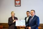Iwona Gibas z Zarządu Województwa Małopolskiego przekazuje samorządowcom z Trzyciąża promesę, symboliczny czeka na 5 milionów złotych 