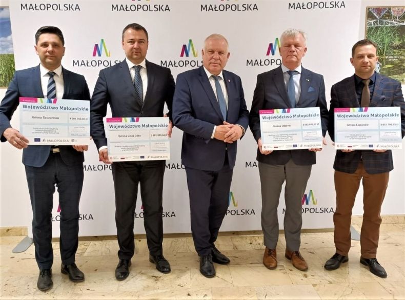 Wicemarszałek Ryszard Pagacz stoi z beneficjentami.