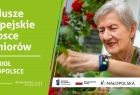 Plakat kampanii: napis Fundusze Europejskie w trosce o seniorów. Tele-Anioł w Małopolsce oraz zdjęcie starszej kobiety z opaską na ręce